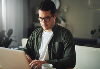 Man working seriously on laptop at home