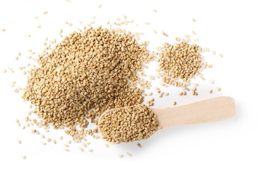Organic integral sesame seeds with wooden spoon isolated on white background, top view