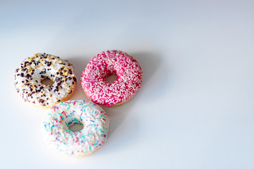 three delicious donuts on white background