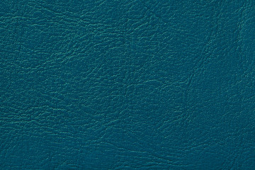 Dark navy blue leather texture background, closeup. Turquoise cracked backdrop from wrinkle skin