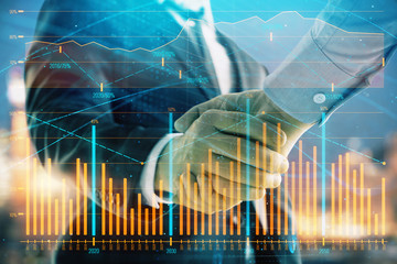 Double exposure of financial chart on cityscape background with two businessmen handshake. Concept of financial analysis and investment opportunities