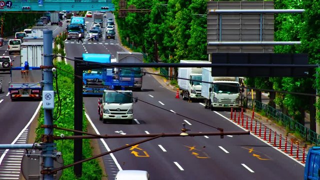 A timelapse of car street at Kanpachi avenue in Tokyo daytime long shot tilt