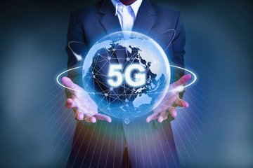 5G network wireless systems and internet of things with businessman holding Abstract global with wireless communication network on space background . - Image