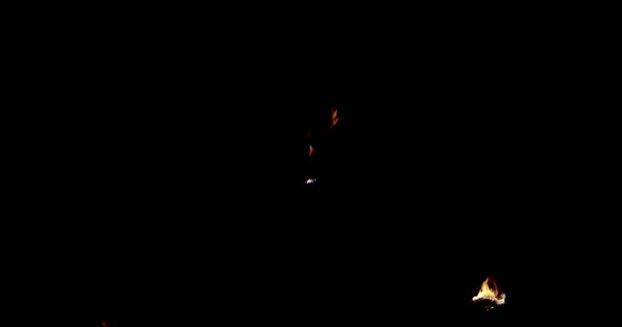 Muscular man spits fire in fire show at night-slow motion