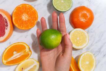 Citrus fruits. Orange, lemon, grapefruit, mandarin and lime on a trendy stone background