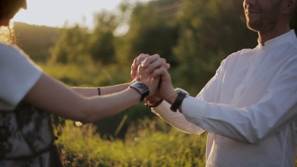Romantic dance of lovers in sunset light.