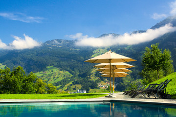 Luxury resort with pool overlooking the mountains, Switzerland.