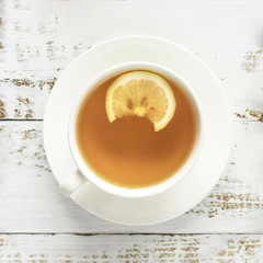 Cup of hot tea on wooden surface