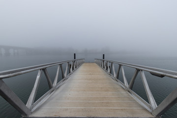 A pier view into the fog.