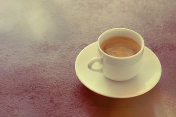 Hot cup of espresso coffee on a table