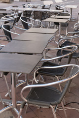 restaurant cafe open terrace with wooden tables and steel chairs