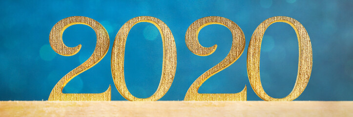 Happy New Year 2020. Creative text Happy New Year 2020 written in gold wooden letters. Banner.