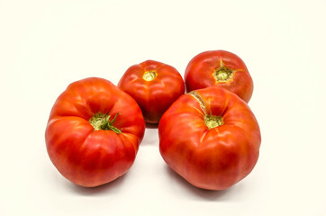 Summer harvest of very large and tasty red tomatoes grown in Armenia, lying on a white background