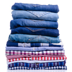Stack folded casual shirt and jeans on white background isolation