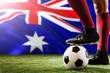 Close up legs of Heard Island and Mcdonald Islands football team player in red socks, shoes on...