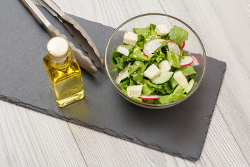 Fresh vegetable salad with cheese, cucumber and radish