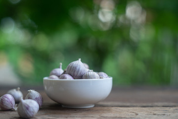 Top view of herbal vegetable ingredients, fresh garlic, on old wooden table, cooking preparation concept