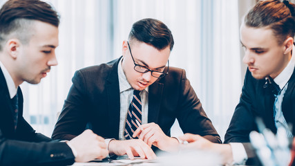 Corporate meeting. Business partners working on project, discussing conditions in conference room.