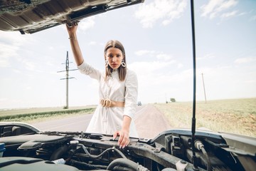 In a young beautiful woman's car was broken during the trip, she tries to call the tow truck