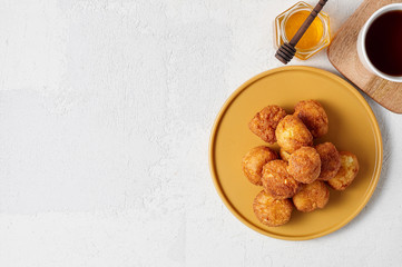 Cottage cheese balls doughnuts is jam-packed with jelly filling, cup of tea and honey