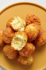 Cottage cheese balls doughnuts is jam-packed with jelly filling on yellow plate