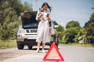 In a young beautiful woman's car was broken during the trip, she tries to call the tow truck