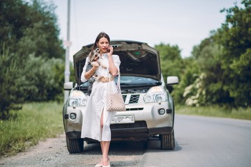 In a young beautiful woman's car was broken during the trip, she tries to call the tow truck