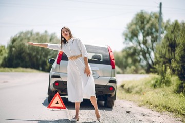 In a young beautiful woman's car was broken during the trip, she tries to call the tow truck
