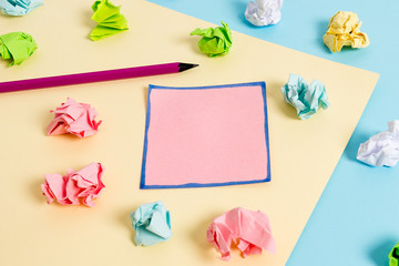 Colored crumpled papers empty reminder blue yellow background clothespin