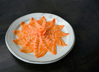 Slices of raw Salmon sashimi on dish