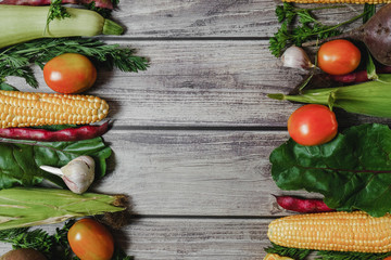 Healthy food clean eating selection. Corn, tomatoes, zucchini, carrot, beetroot, garlic, bean on wooden background. Food concept. Flat lay, top view. Free space for your text.