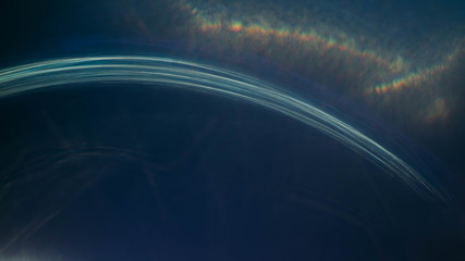 Defocused blue arc lines, strokes, yellow glow. Lens flare effect. Dark abstract art background.