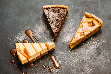 Bakery food. Dessert assortment. Walnut tart, apple pie and sprinkled with sugar powder. Copy space.