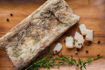 Rustic salted lard lies on a napkin on a wooden surface