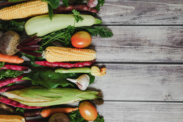Healthy food clean eating selection. Corn, tomatoes, zucchini, carrot, beetroot, garlic, bean on wooden background. Food concept. Flat lay, top view. Free space for your text.