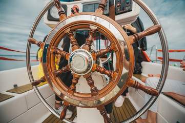 Wheel of a wooden antique sailing yacht.