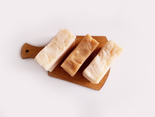 Handmade soap on a cutting board on a white background