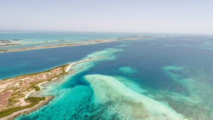 Obraz na płótnie Canvas Caribbean: Vacation in the blue sea and deserted islands. Aerial view of a blue sea with crystal water. Great landscape. Beach scene. Aerial View Island Landscape Los Roques