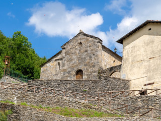 Fototapeta na wymiar Ancient church in Vagli Sotto, in Garfagnana, Italy. Dedicated to St Augustine it dates back to the 11th century and sits next to a former convent.