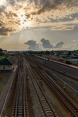 Fototapeta premium View of the railway tracks going into the distance. The sky before sunset with clouds