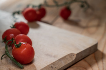 cherry tomatoes on a wooden cutting board