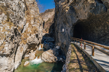 View of a famous Dovzan Gorge near Trzic, Slovenia. Big rock walls, cascade and a stream in Dovžan...