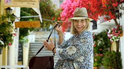 Beautiful blonde happy cheerful woman looking at the camera and smiling. Corfu. 4K