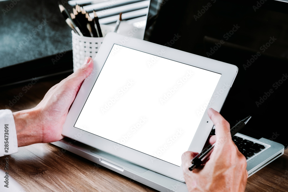 Poster mock up digital tablet with blank screen and business analysis financial data on laptop computer.