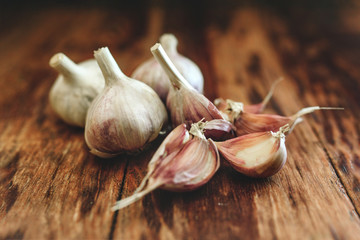 A lot of garlic on a wooden background.