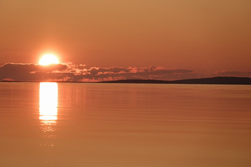 Soft dawn over the sea surface before the sun appears over the horizon on the White sea
