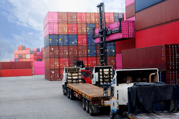The truck is waiting to load the container in the port.