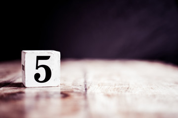 Number 5 isolated on dark background- 3D number five isolated on vintage wooden table