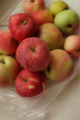 Naklejka na ściany i meble pile of red ripe apples, natural summer fruits