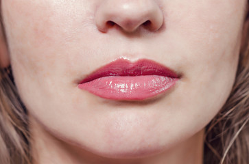 Fototapeta premium Female lips with red lipstick, nice smile close-up. Women's heal